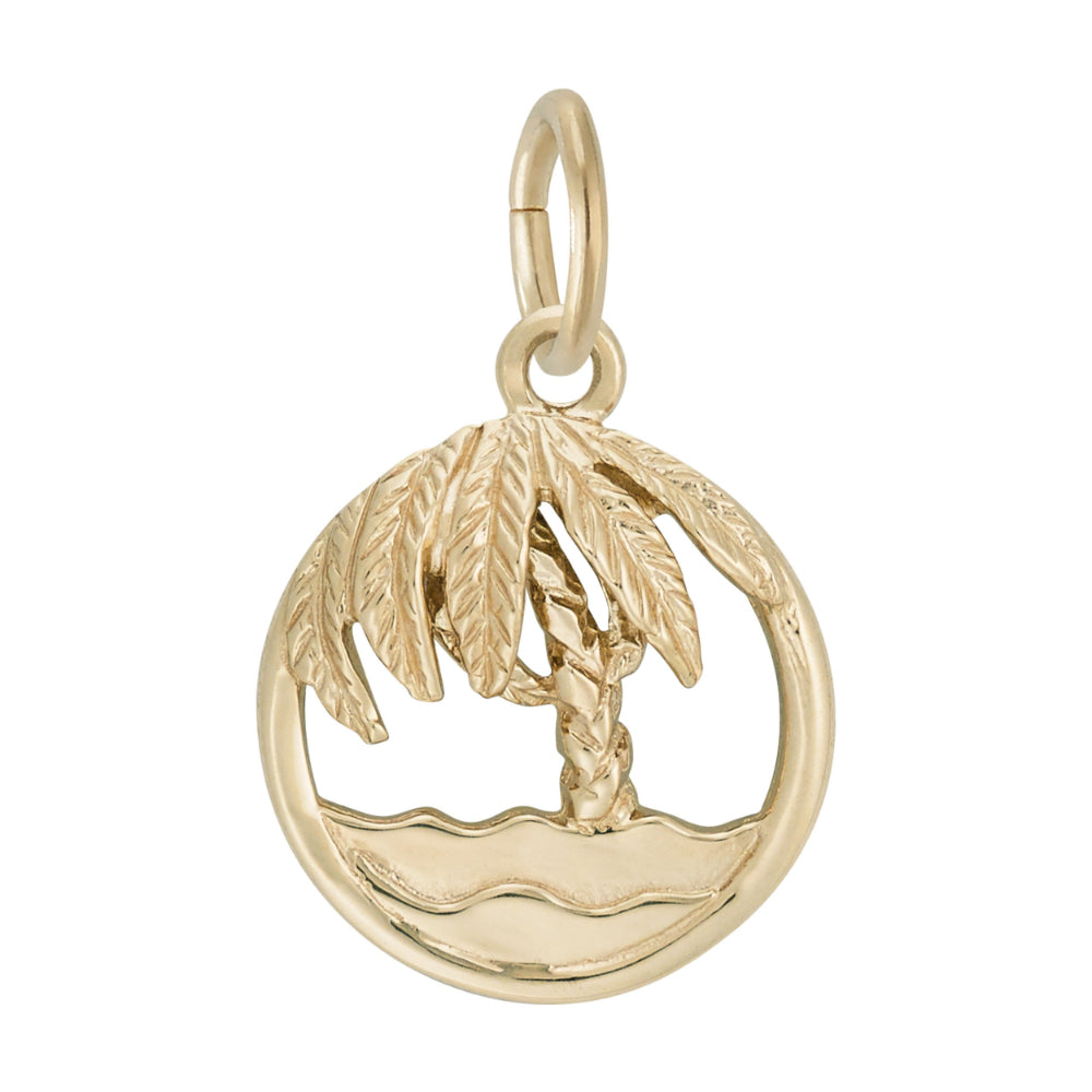 Round gold charm with cutouts ion the middle to from a palm tree and beach, on a white background