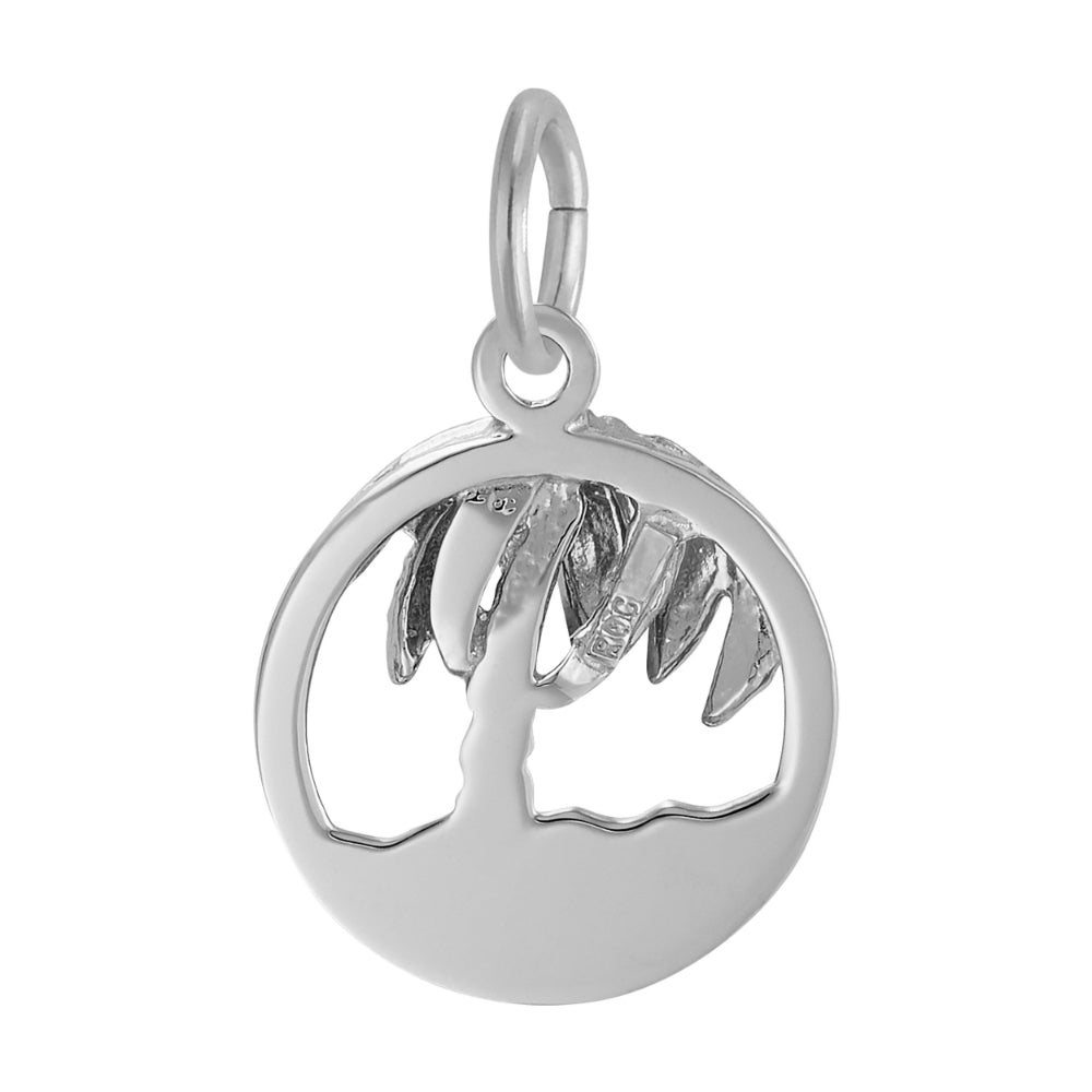 Reverse side of a Round silver charm with cutouts ion the middle to from a palm tree and beach, on a white background