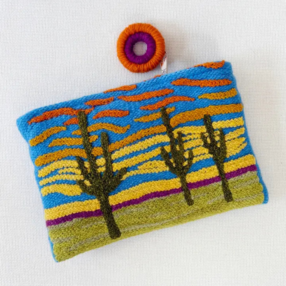 Handcrafted pouch with desert landscape design on a white background
