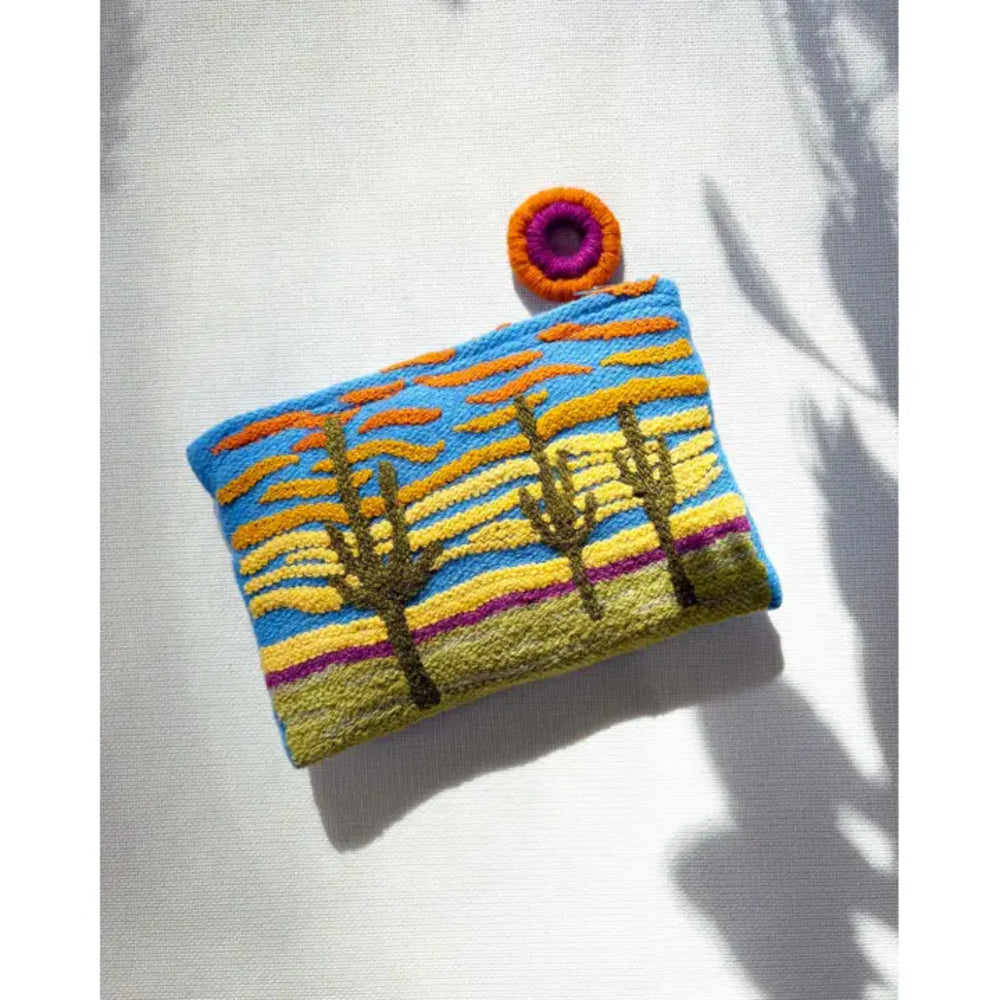 Handmade pouch with desert landscape design on a white background