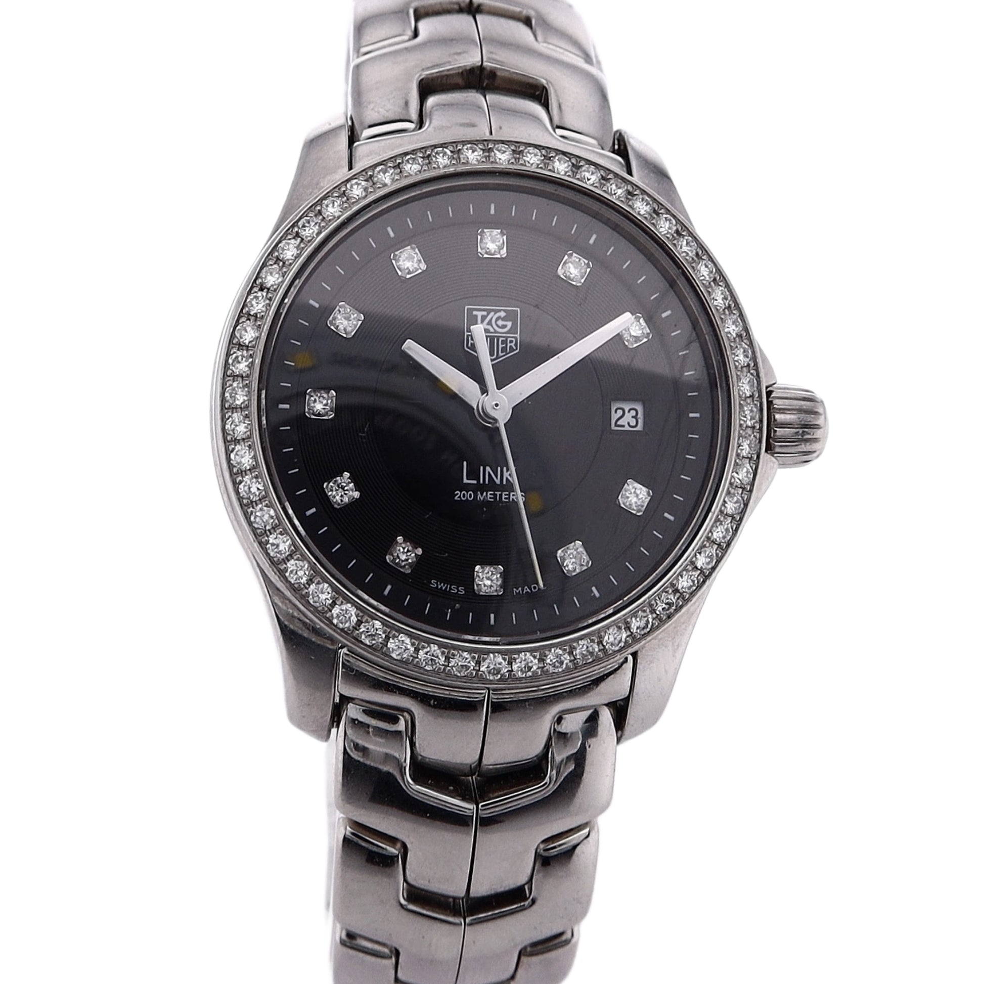 Silver TAG Heuer watch with a black dial, diamond indexes, and diamond bezel on a white background