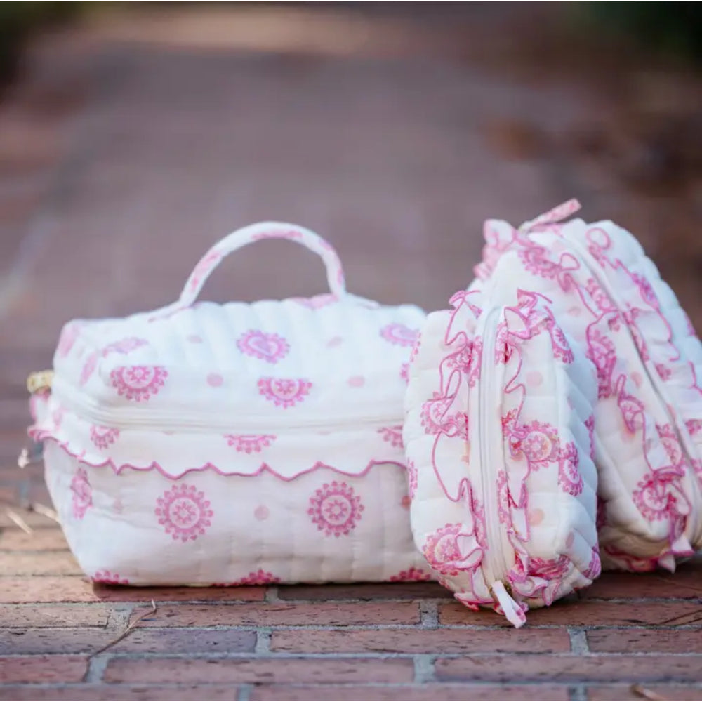 Floral-patterned fabric cosmetic bag set on a wooden surface