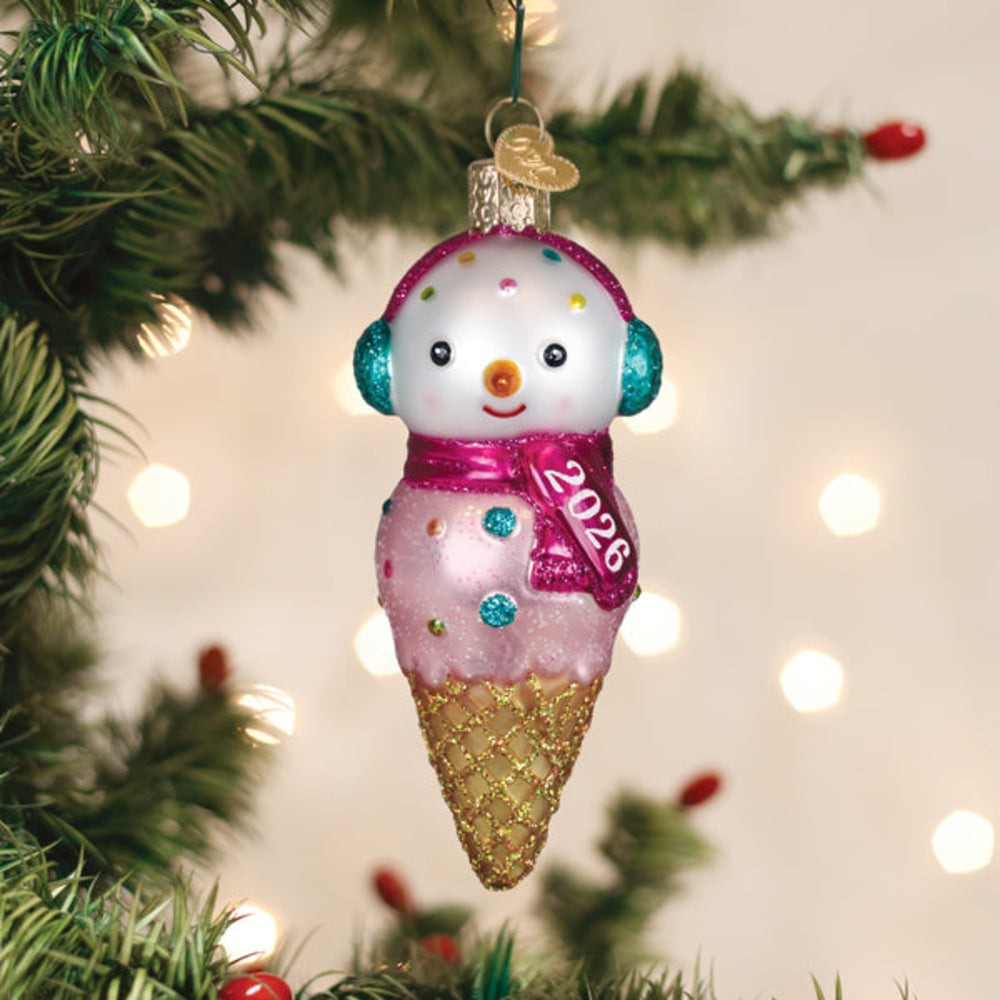 Christmas ornament shaped like a snowman in an ice cream cone with '2026' on a tree background.