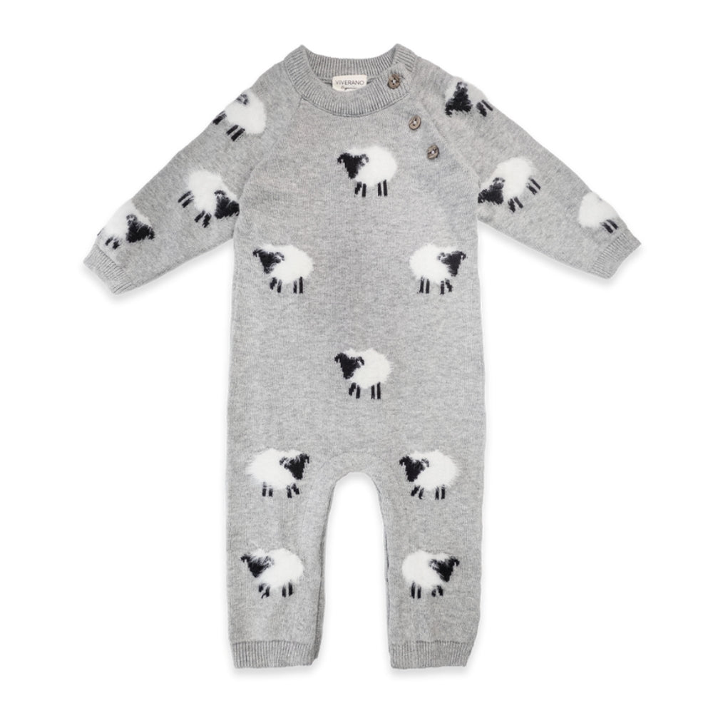 A light gray long-sleeve baby romper with an all-over knit sheep pattern in black and white, featuring a crew neck and snap closures at the shoulder.