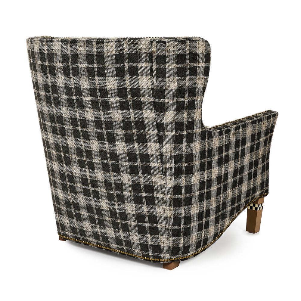 Black plaid patterned shoe with a wooden sole on a white background