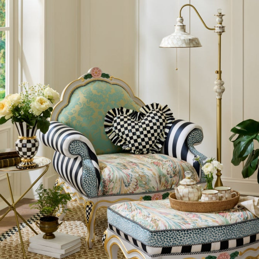Decorative armchair with floral and checkered patterns in a stylish room.