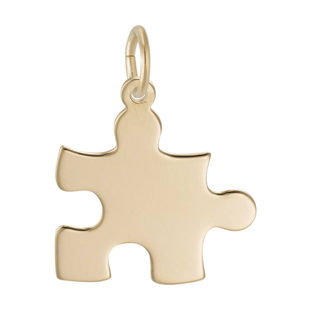 Gold puzzle piece pendant on a white background