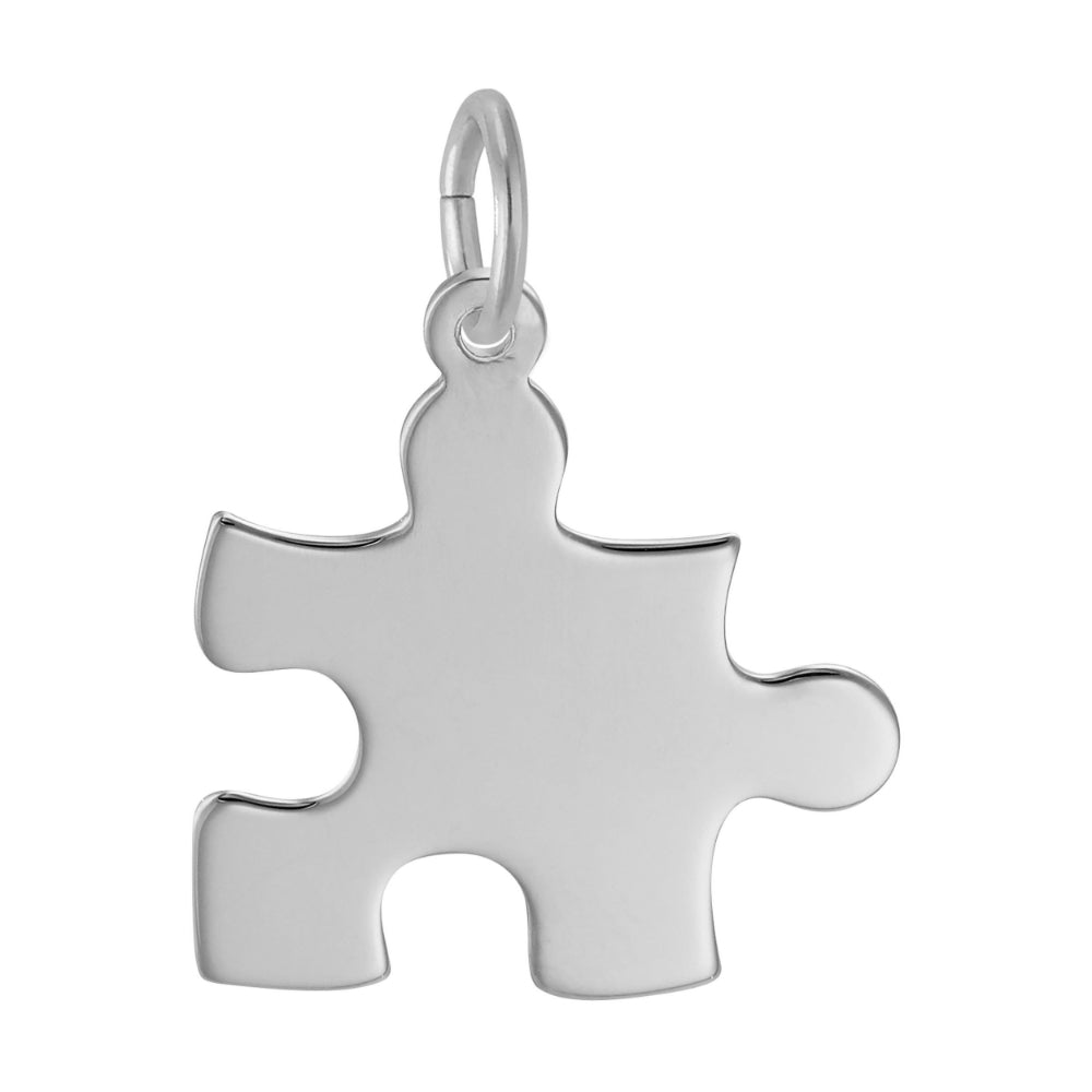 Silver puzzle piece pendant on a white background