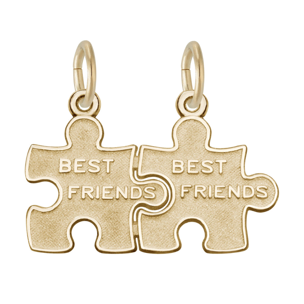 Gold break apart puzzle piece charm with 'BEST FRIENDS' engraved on them on a white background