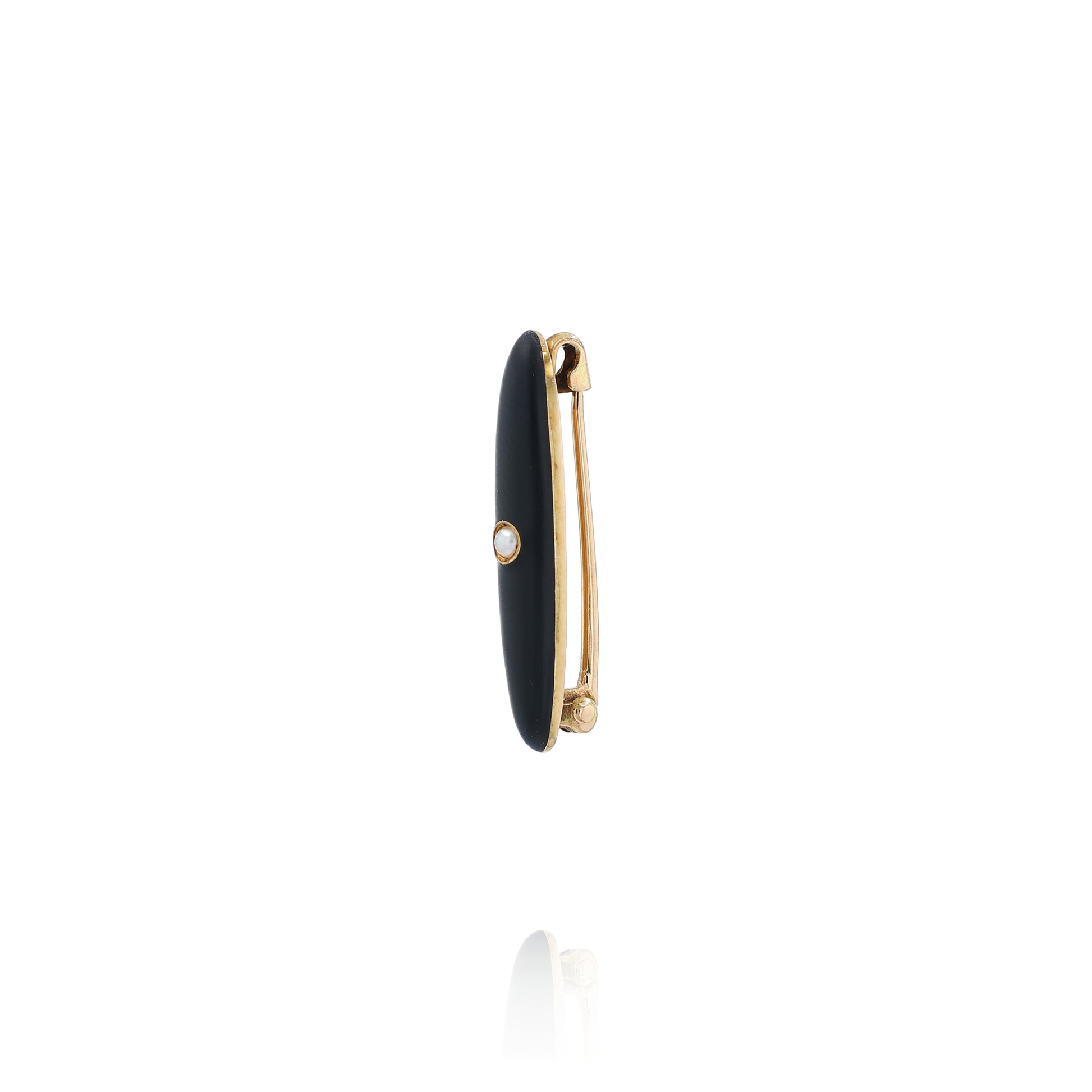 Yellow gold and black enamel pin with a pearl center on a white background