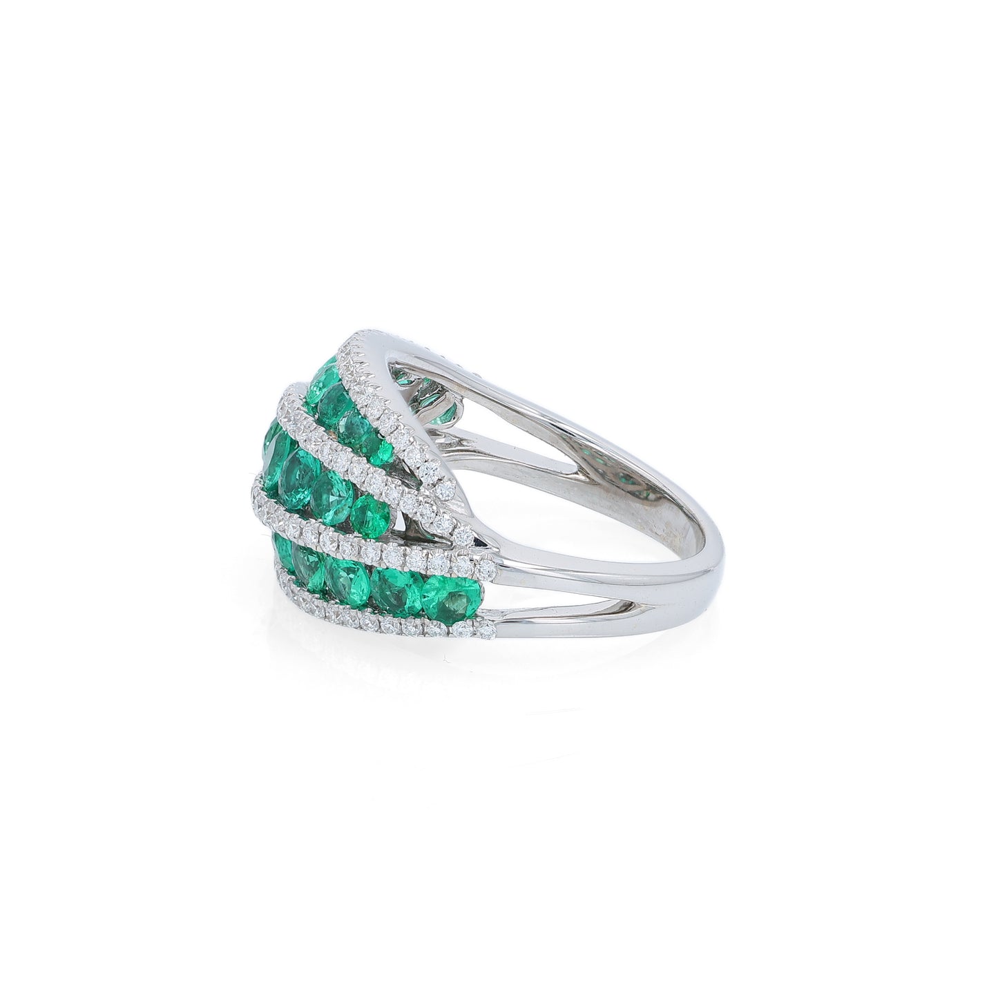 White gold multi-row graduated emerald and diamond ring on a white background