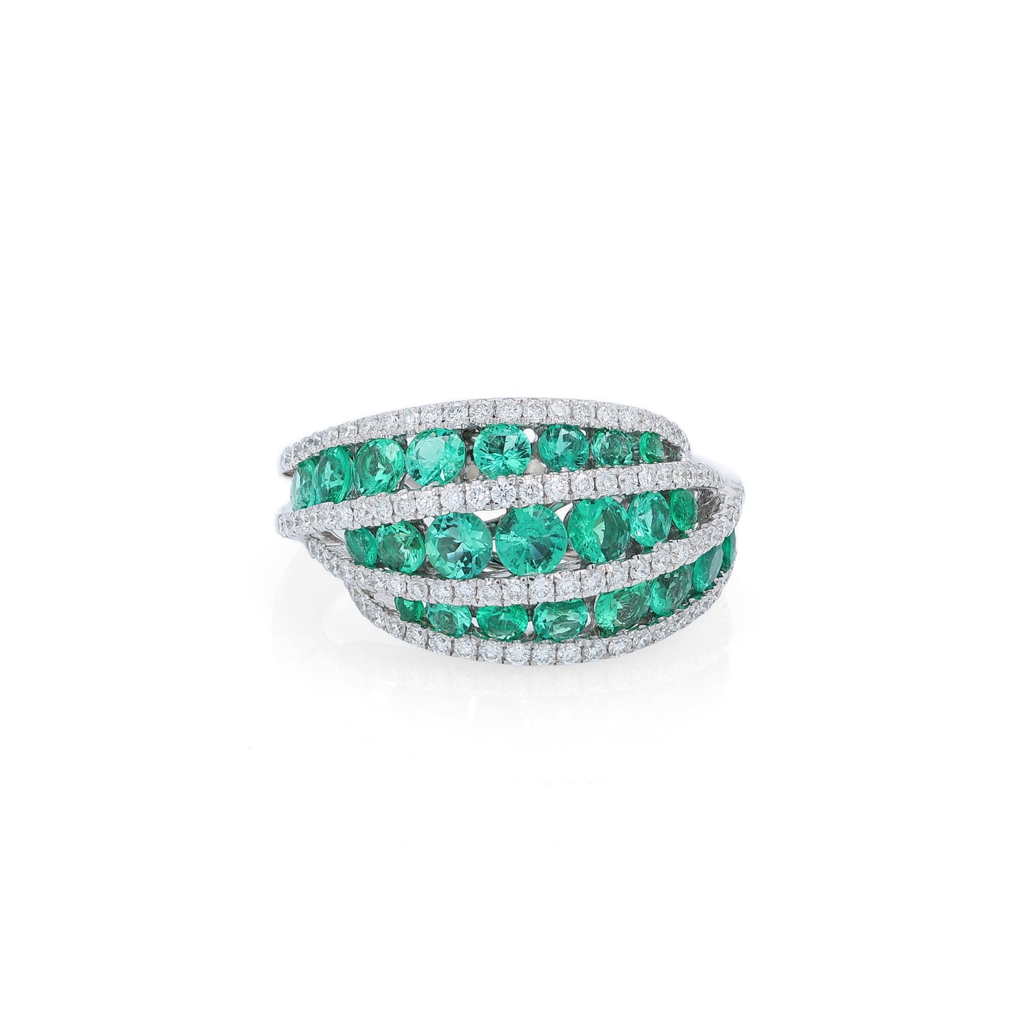 White gold multi-row graduated emerald and diamond ring on a white background