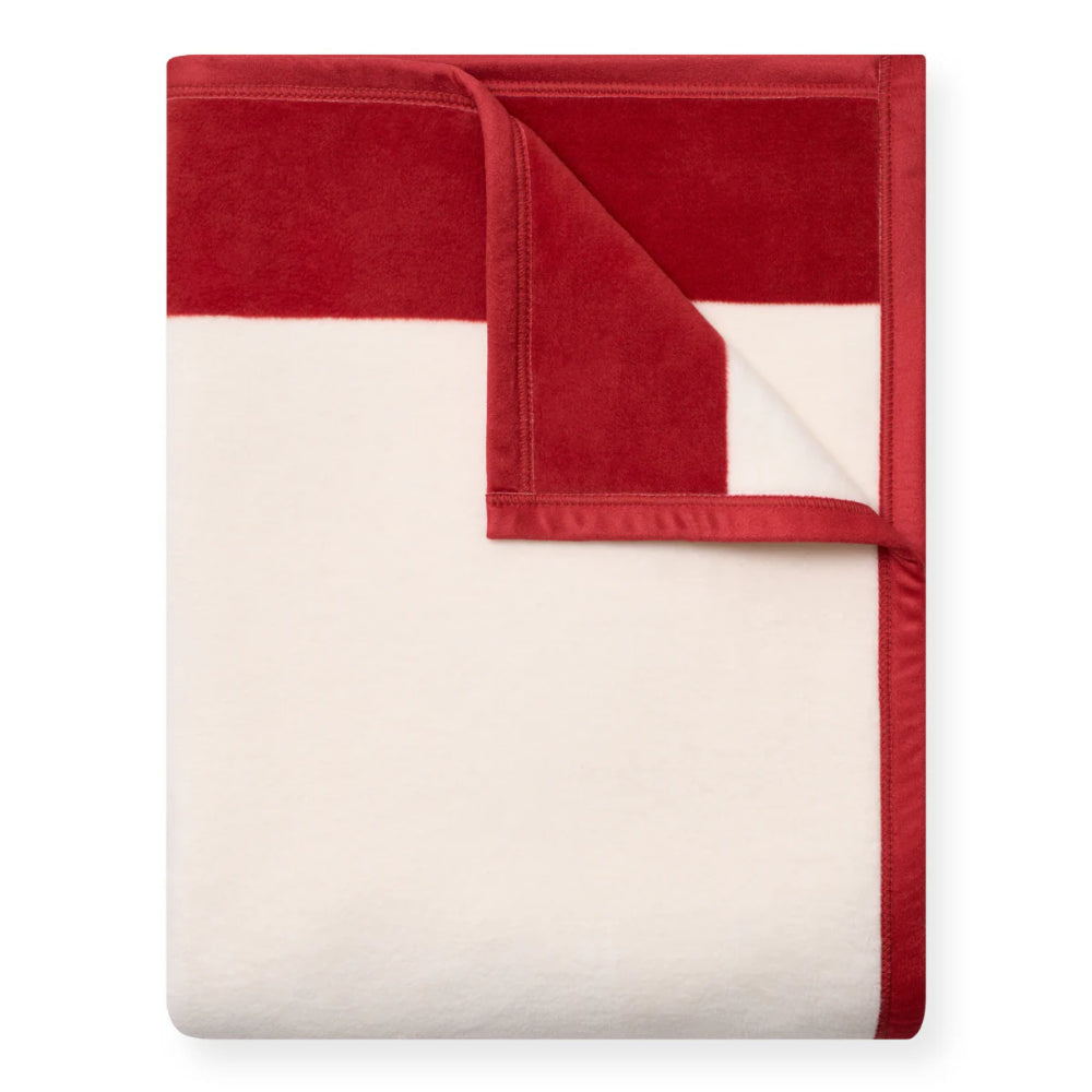 Red and white blanket folded on a white background