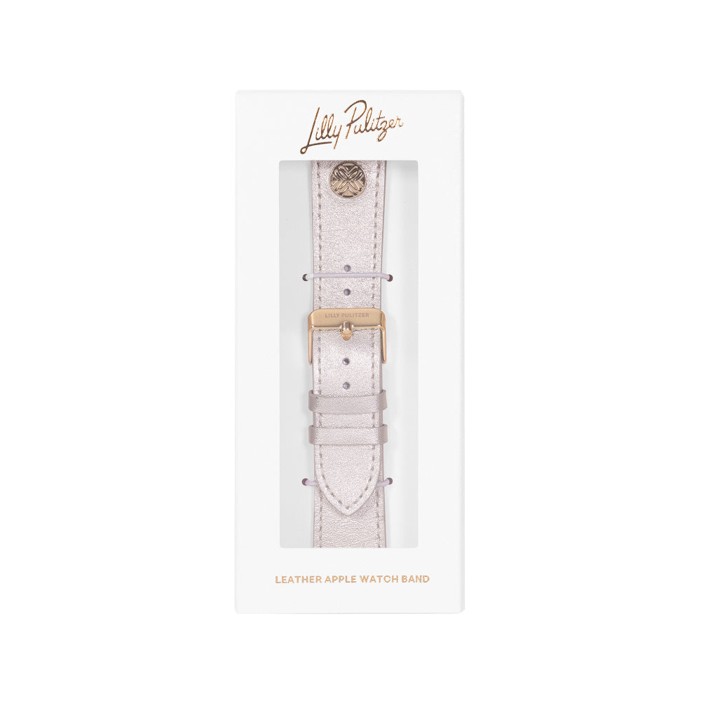 A Lilly Pulitzer light pink textured leather watch band with a gold buckle, presented in its original white retail packaging with a clear window.