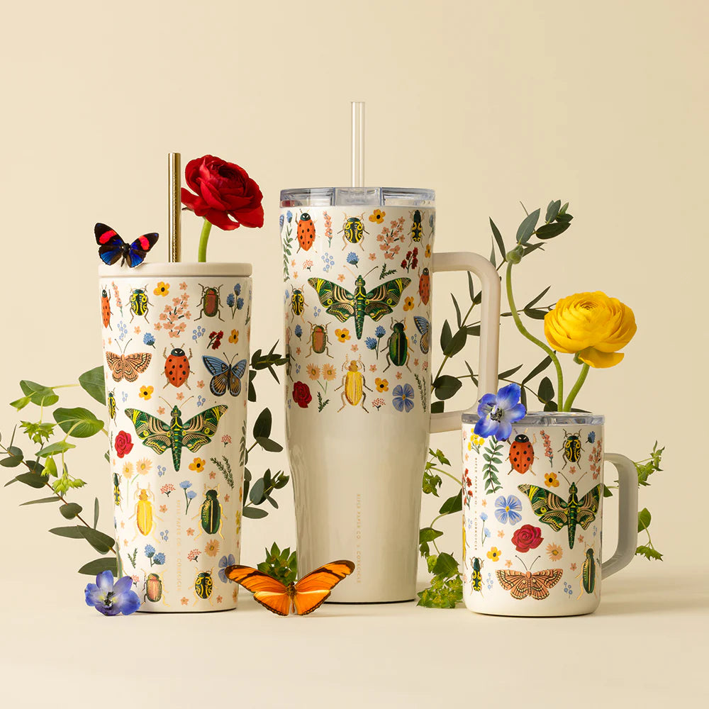 Three tumblers with floral and insect designs on a beige background.