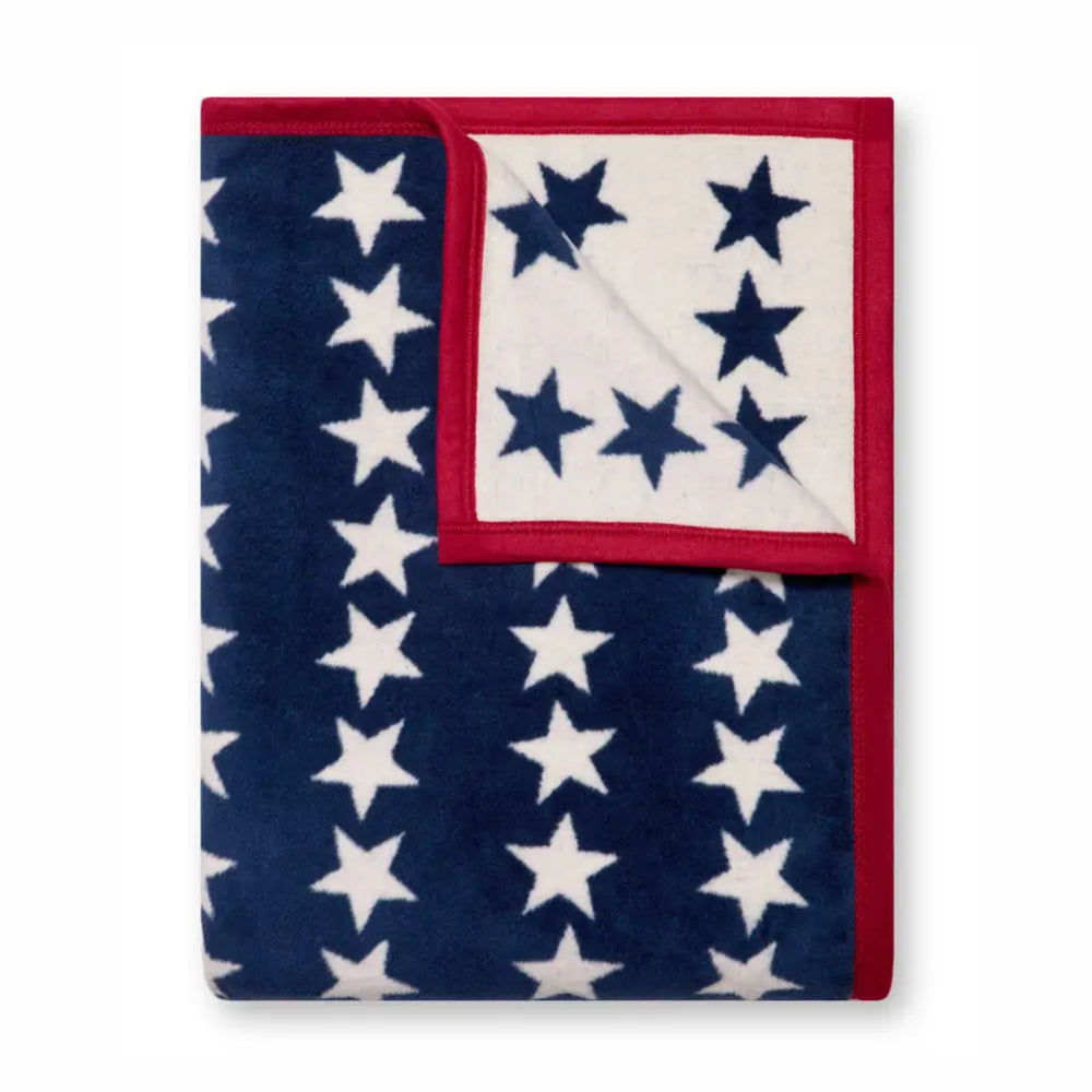 Blanket with red border and blue and white star pattern on a white background
