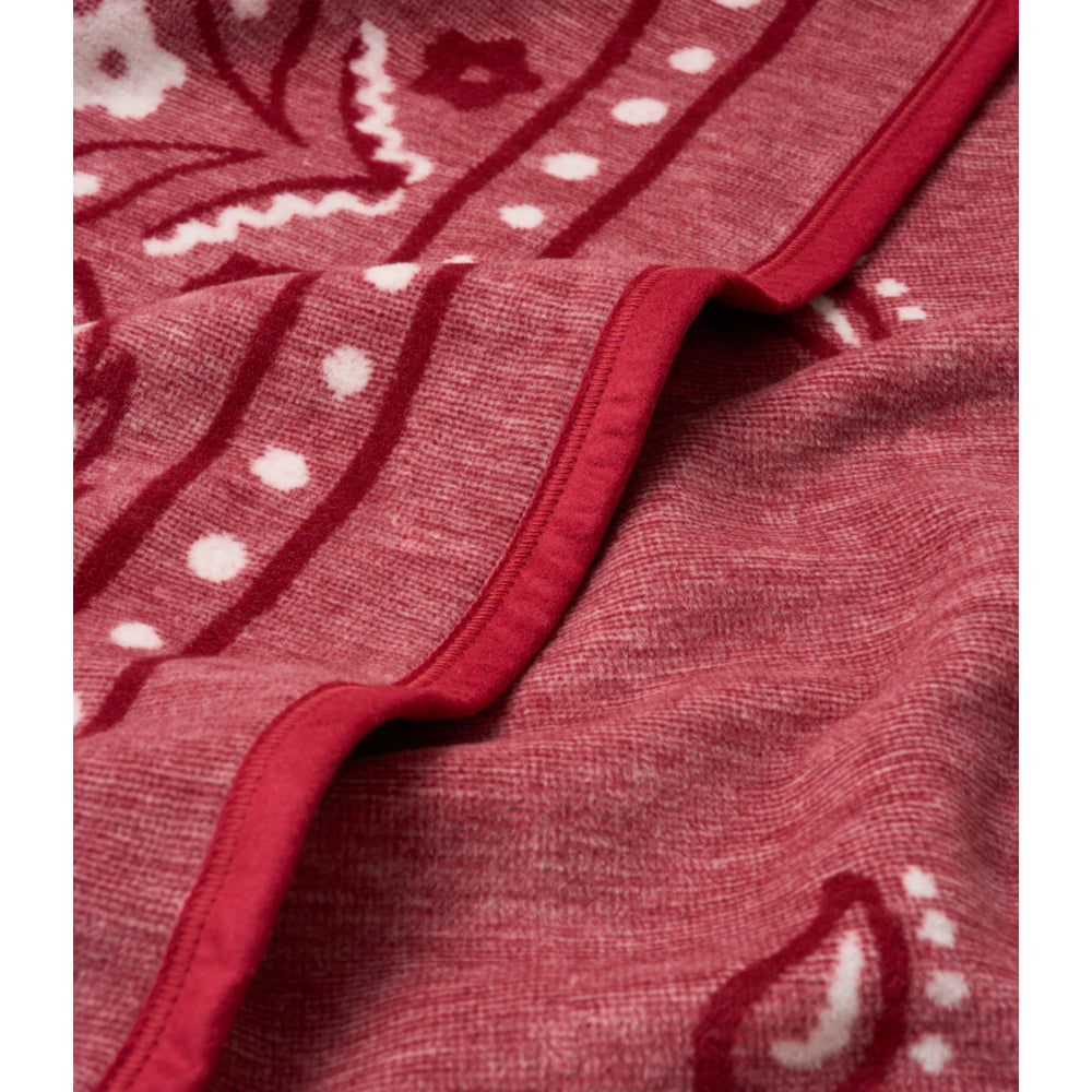 Close-up of a red blanket with white patterns