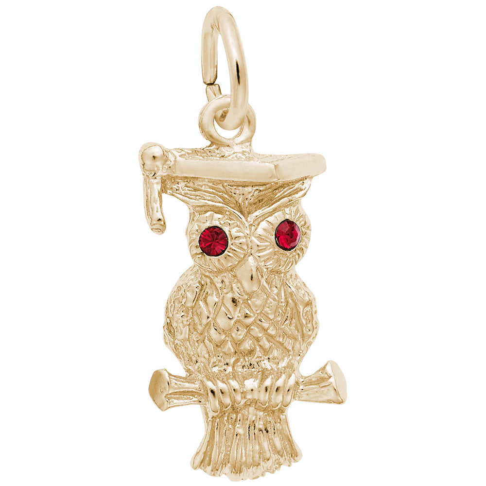 Gold owl charm with red eyes on a white background