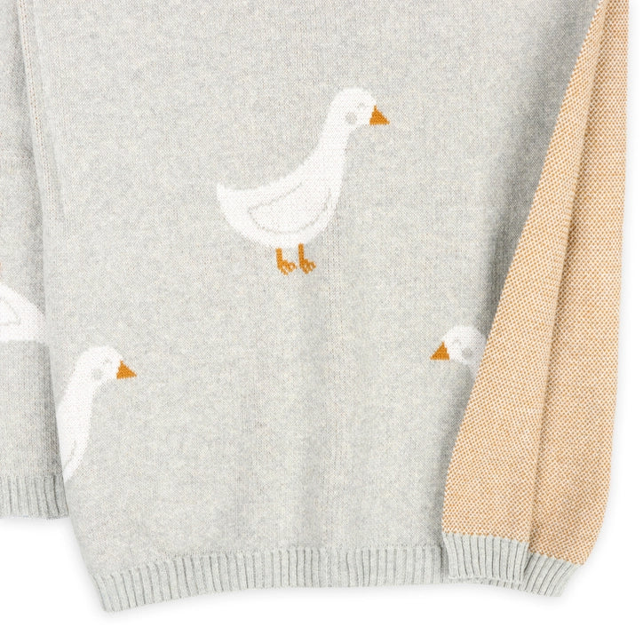 Gray blanket with white duck designs on a white background