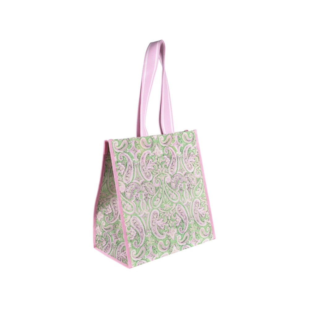 A light green and pink patterned reusable lunch bag with pink handles, shown on a plain white background.