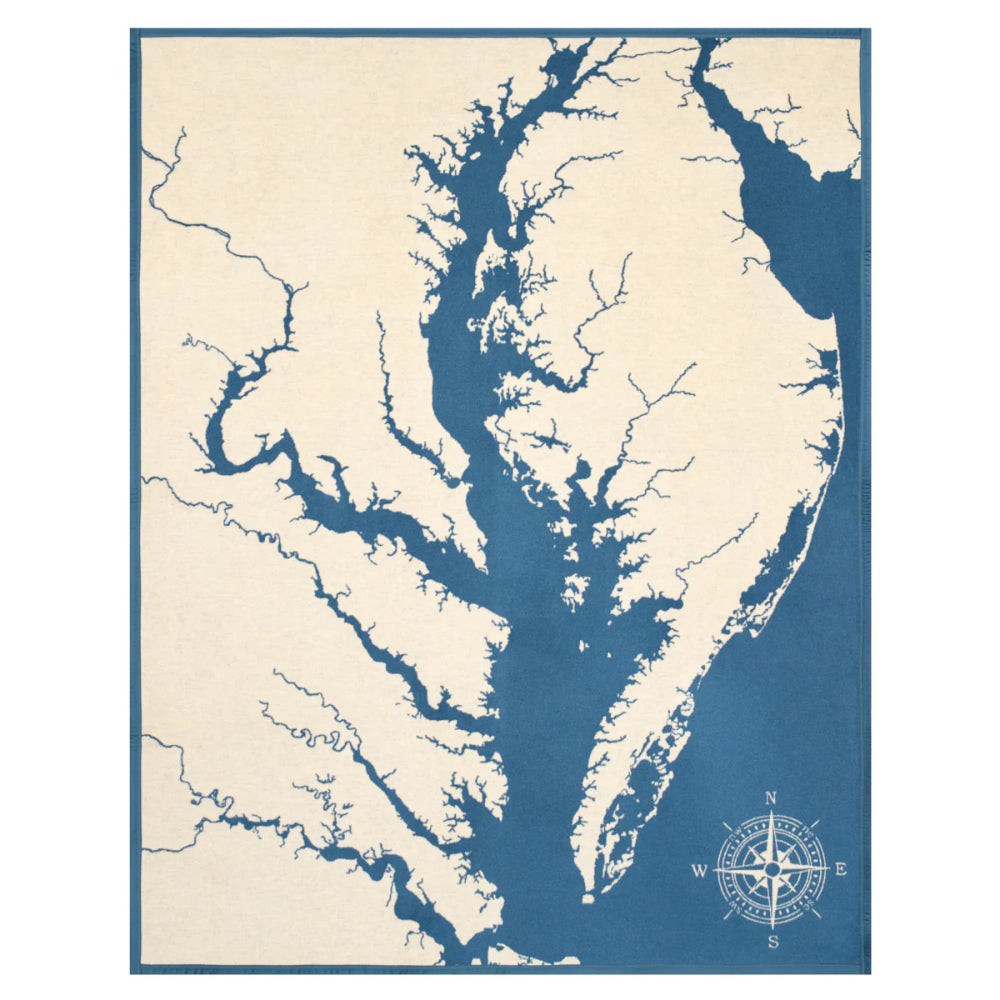 A vintage-style nautical map print of the Chesapeake Bay, featuring a cream-colored landmass and deep blue waterways, framed by a solid blue border with a compass rose in the lower right corner.