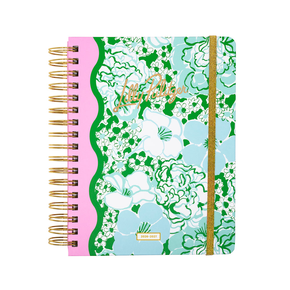 Floral patterned notebook with gold spiral binding on a white background