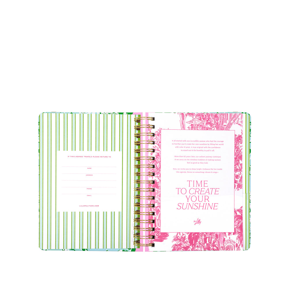 Open notebook with green and pink design on a white background
