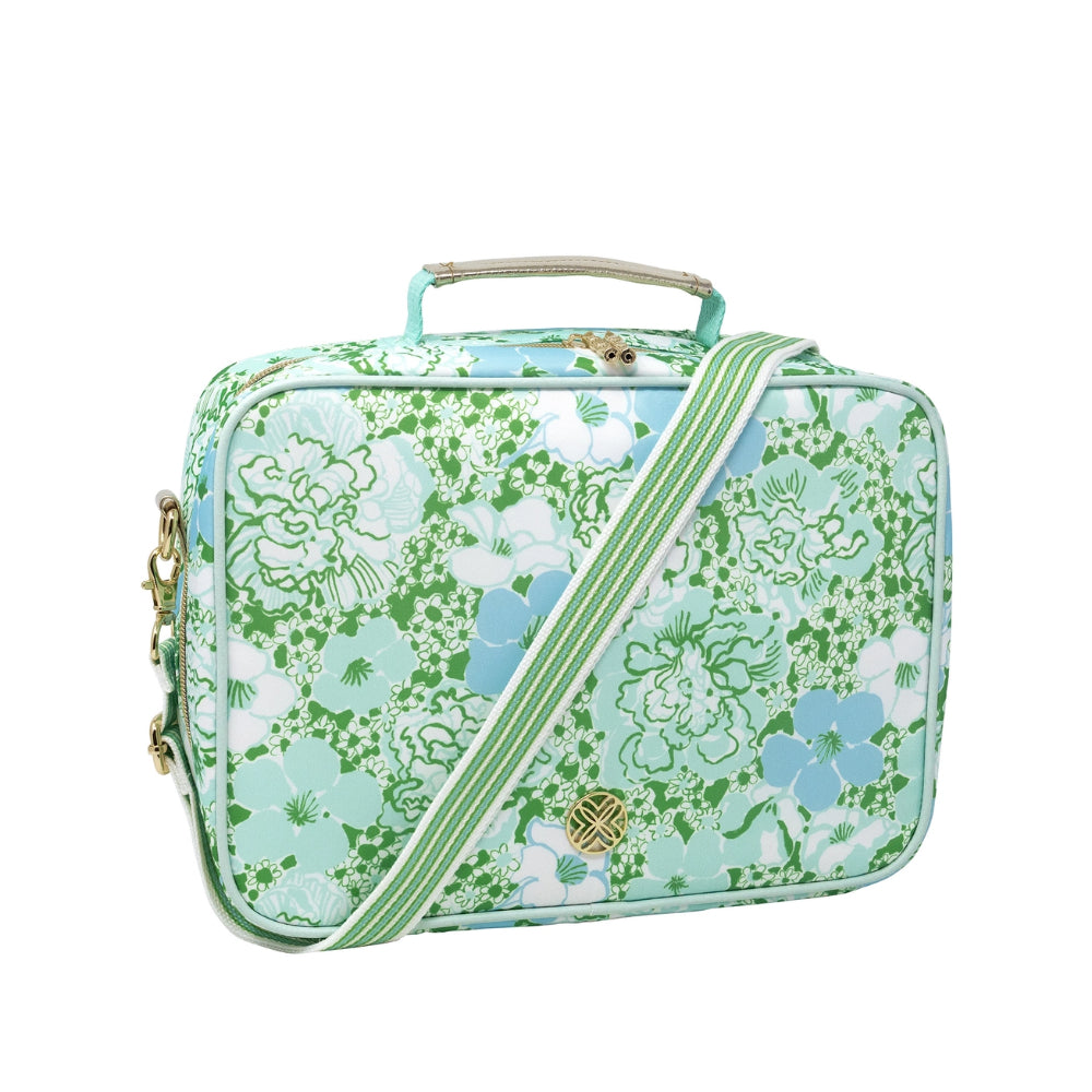 A side angled photo of a green, white and blue floral patterned lunch bag with a zipper, strap and handle on a white background.