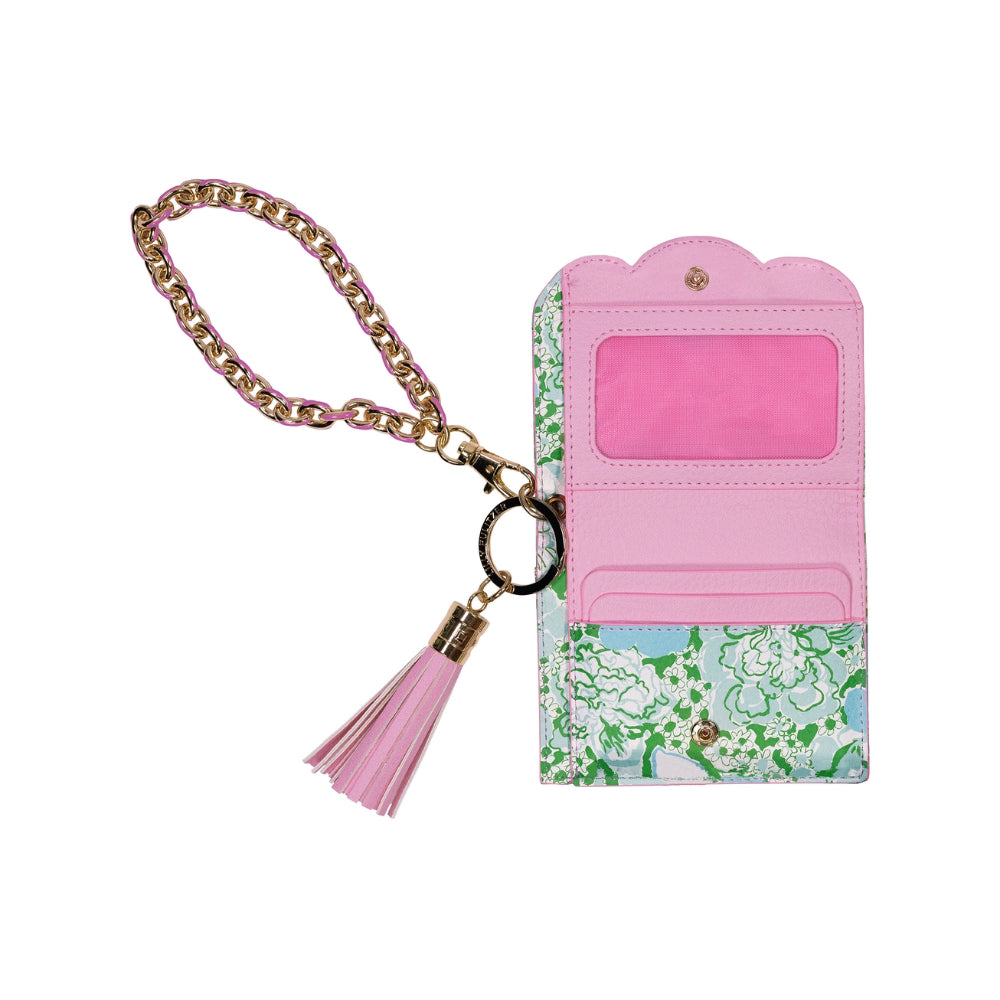 Floral patterned wallet in green,white & blue with pink interior, gold chain, and pink tassel on a white background.