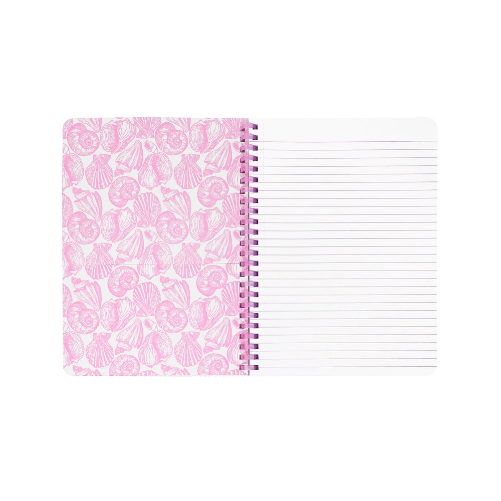 Opened blue notebook with a pink seashell pattern and Lilly Pulitzer branding in gold on the front with ruled notebook paper with a pink binding on a white background.