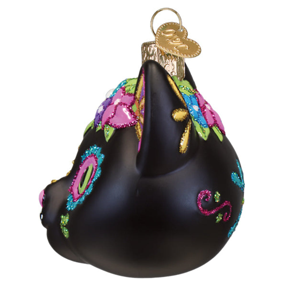 Side profile of decorative black cat ornament with colorful floral patterns on a white background