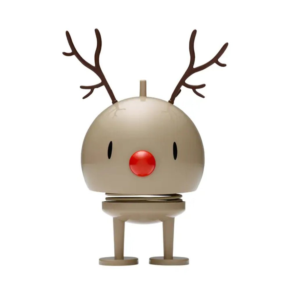 A minimalist reindeer figurine with a round beige head, brown antlers, a bright red nose, and small legs, centered on a plain white background.