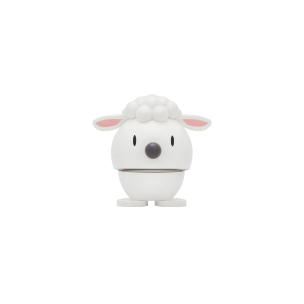 White lam shaped figurine with a spring and face  on a white background
