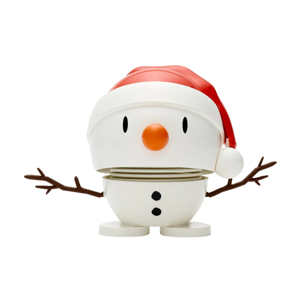 A snowman figurine toy with a white body, red Santa hat, orange nose, black eyes and buttons, and twig-like brown arms, shown on a plain white background.