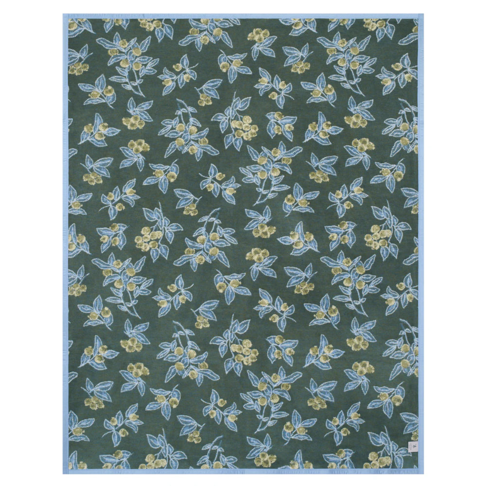 Floral patterned fabric swatch on a green background