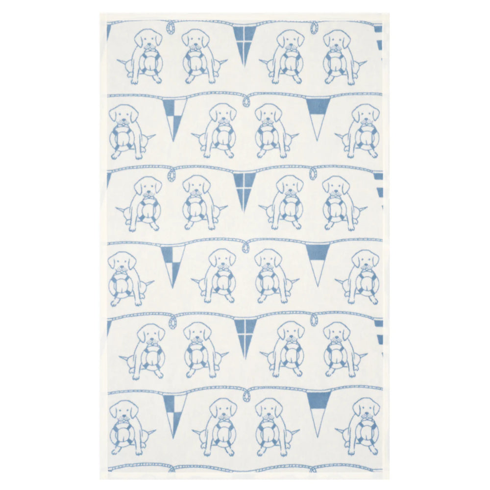 Patterned towel with blue dog illustrations and flags on a white background
