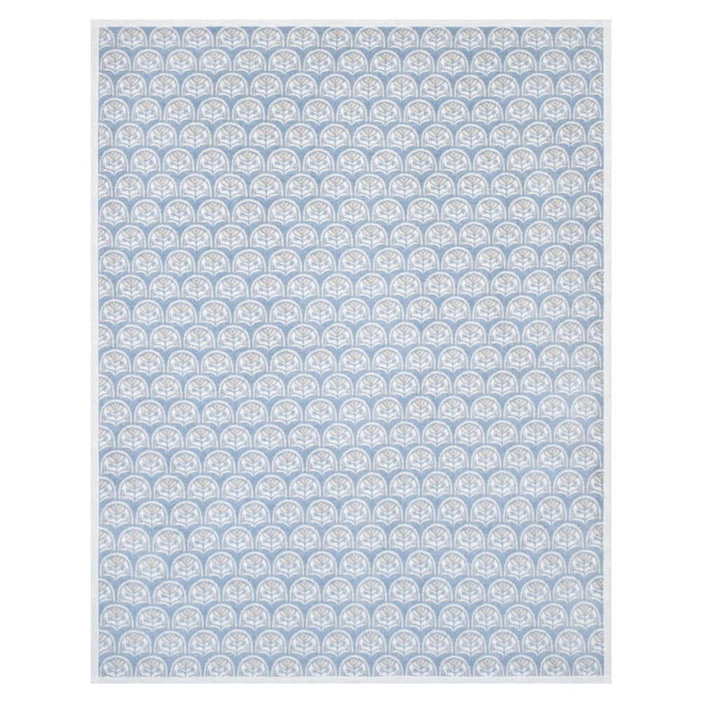 A rectangular area rug with a repeating light blue and white scallop or fan-like pattern, shown flat against a white background.