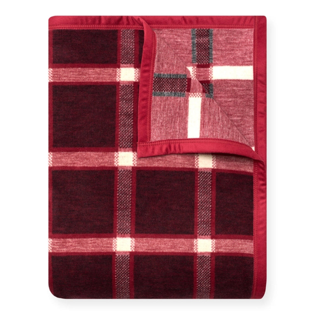 A folded plaid blanket in deep burgundy red, light pink, and white, shown on a clean white background.