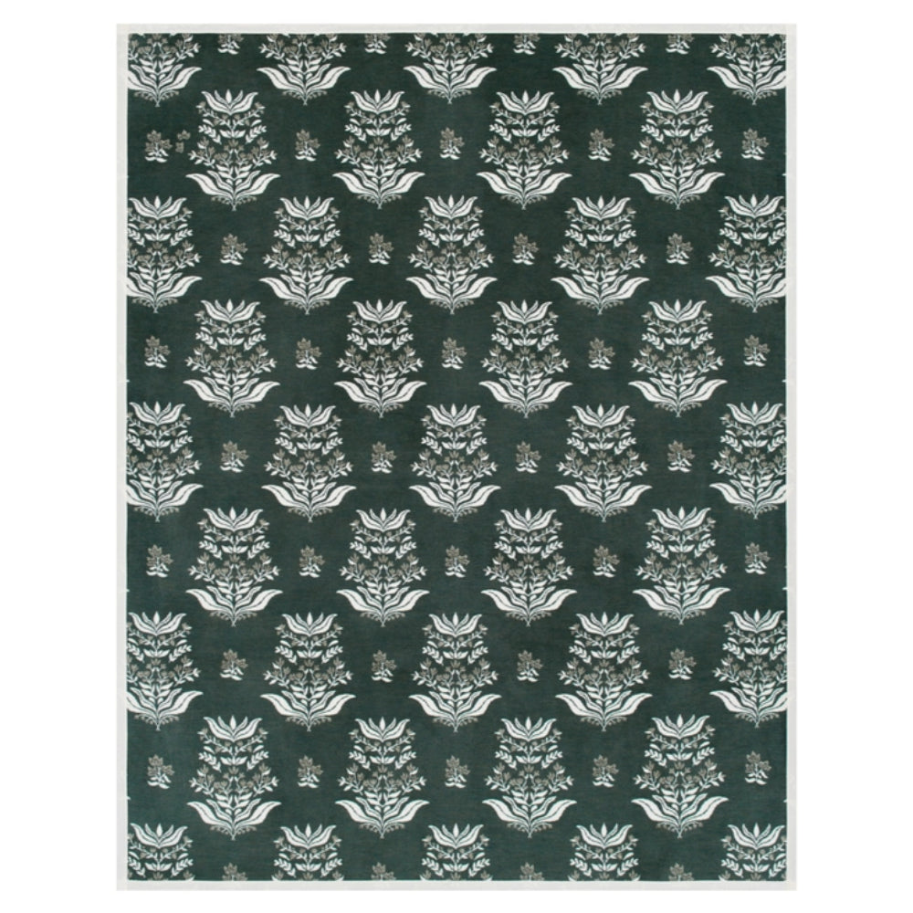 A rectangular blanket with floral and dark designs on a white background. 
