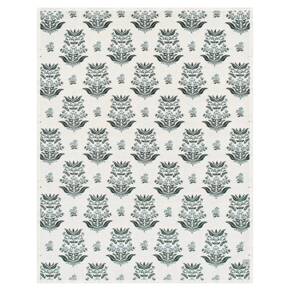 A rectangular blanket with a repeating botanical damask pattern in muted sage green on an off-white background.