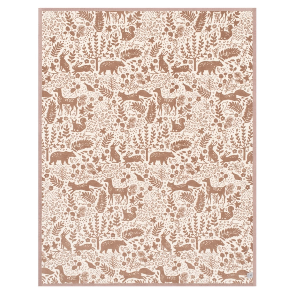 A rectangular blanket with a repeating woodland animal and botanical pattern in warm brown on a cream background, finished with a matching brown border.