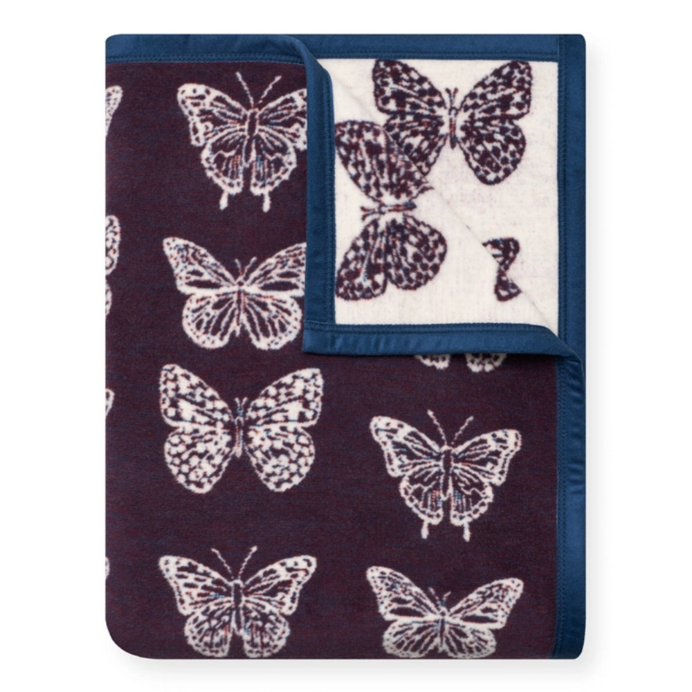 A folded butterflies blanket on a white background. 
