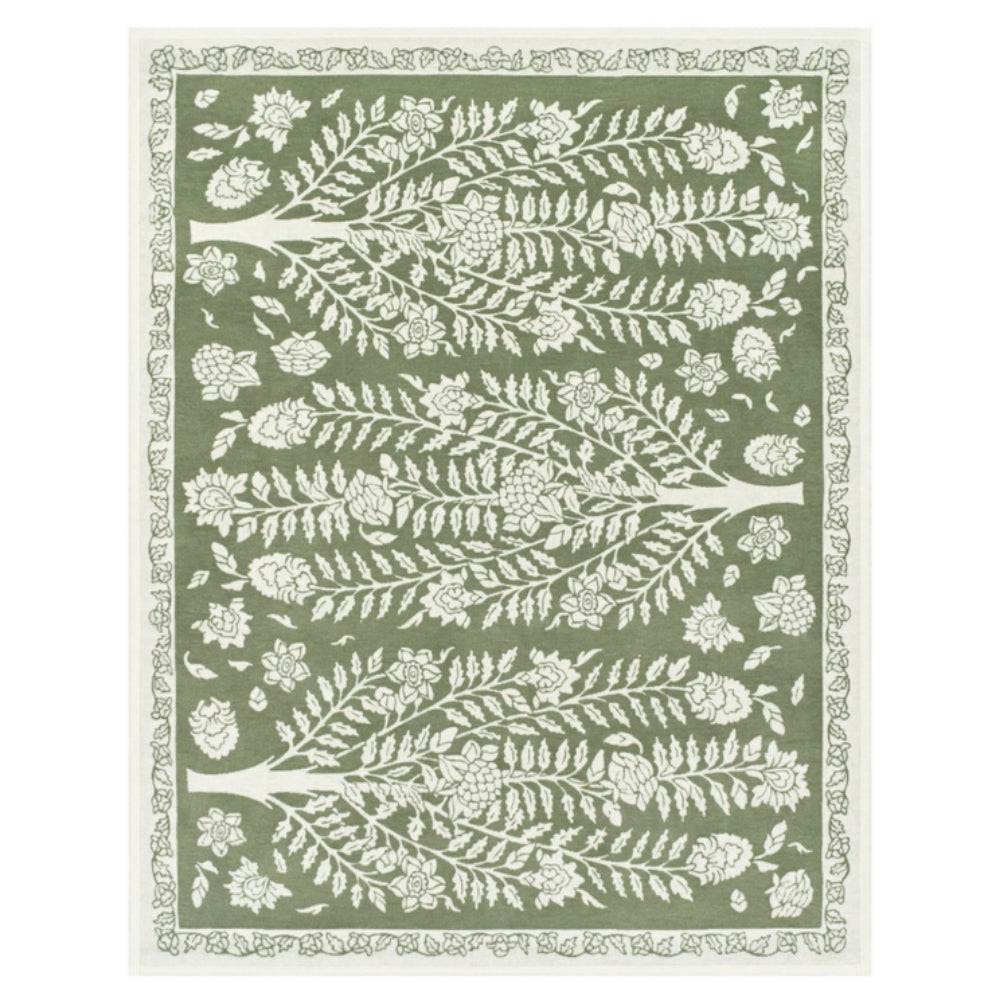 An area blanket featuring a sage green background with a white tree and floral pattern, framed by a white decorative border.