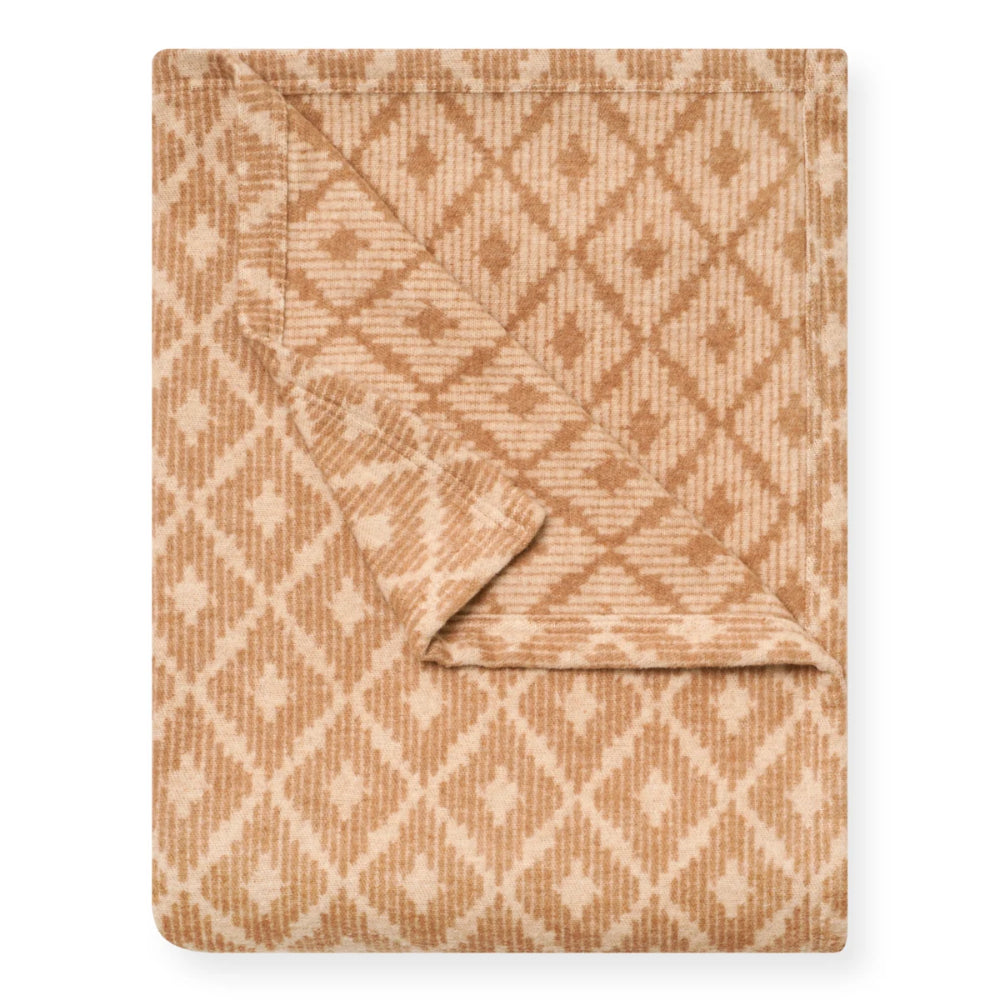 A folded blanket with a warm tan and cream geometric diamond pattern, shown on a clean white background.