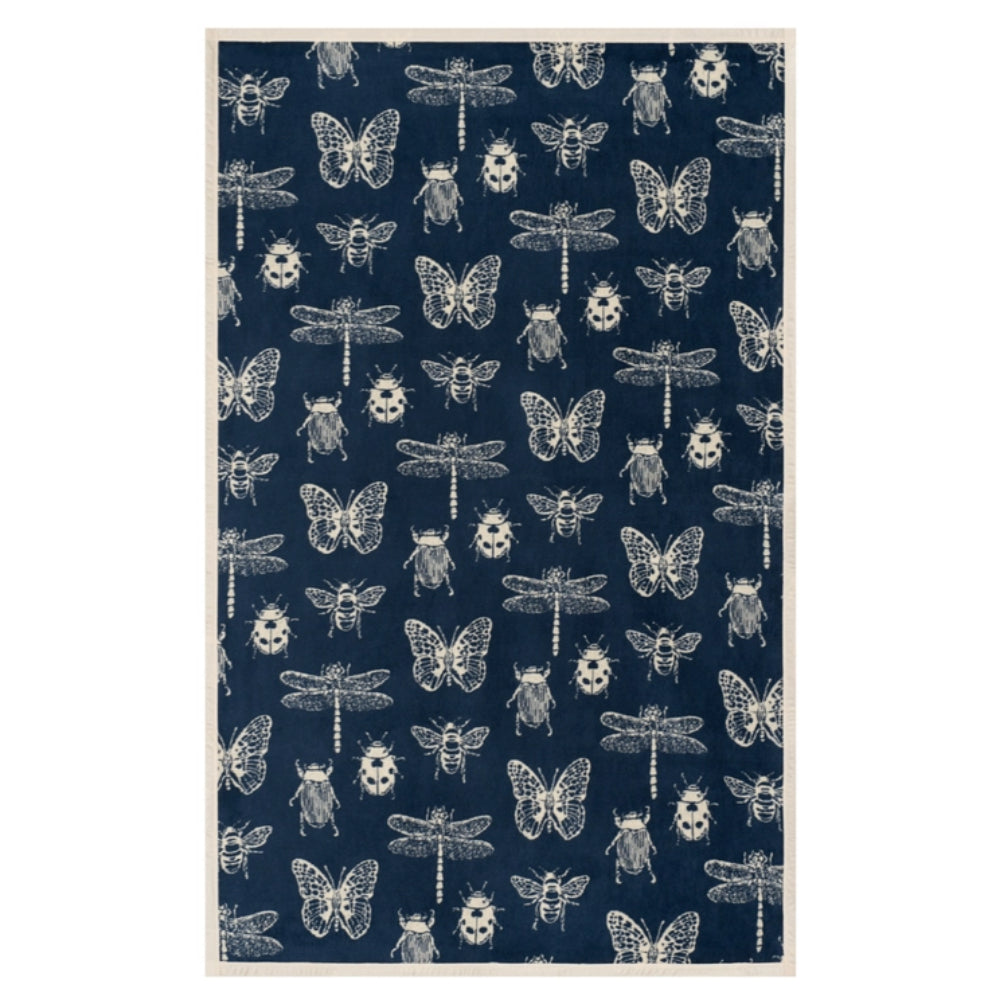 A rectangular blanket with a cream border and a navy blue field featuring a repeating pattern of white illustrated insects, including butterflies, bees, dragonflies, and beetles.
