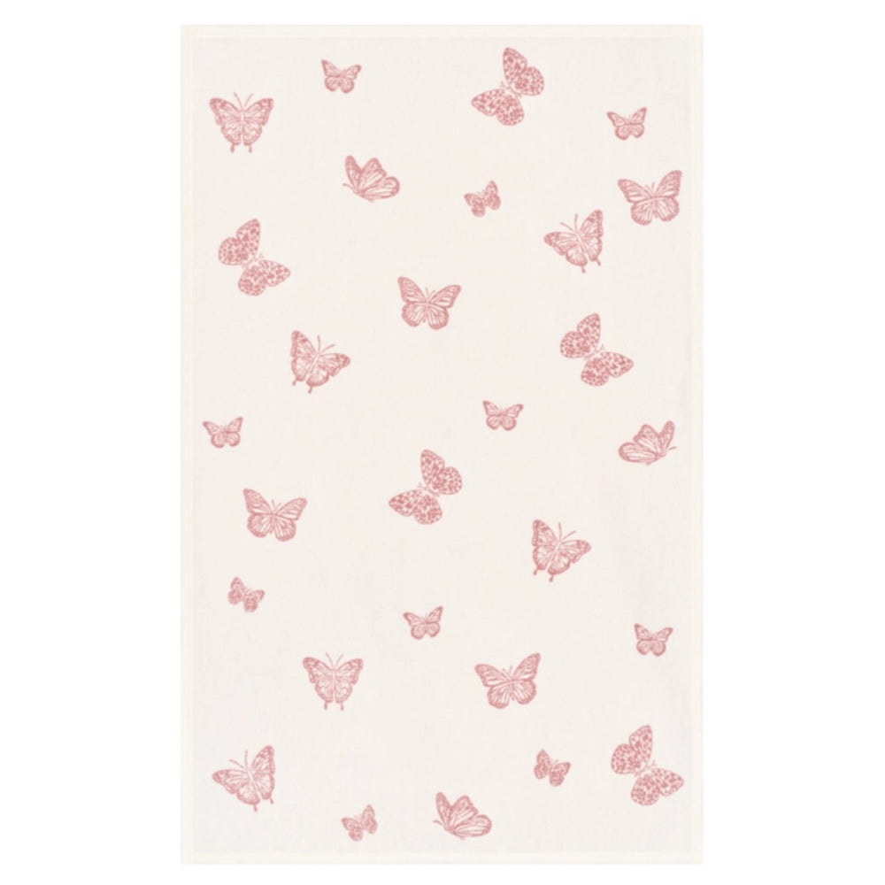 A rectangular cream-colored fabric item, likely a towel or blanket, featuring a scattered pattern of small pink butterflies.