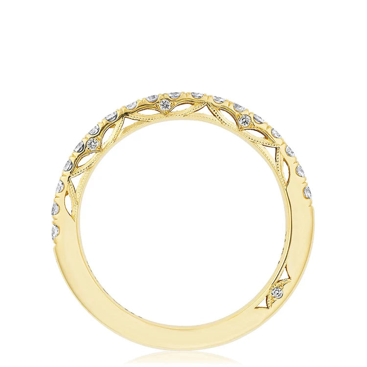 Gold ring with diamond accents on a white background