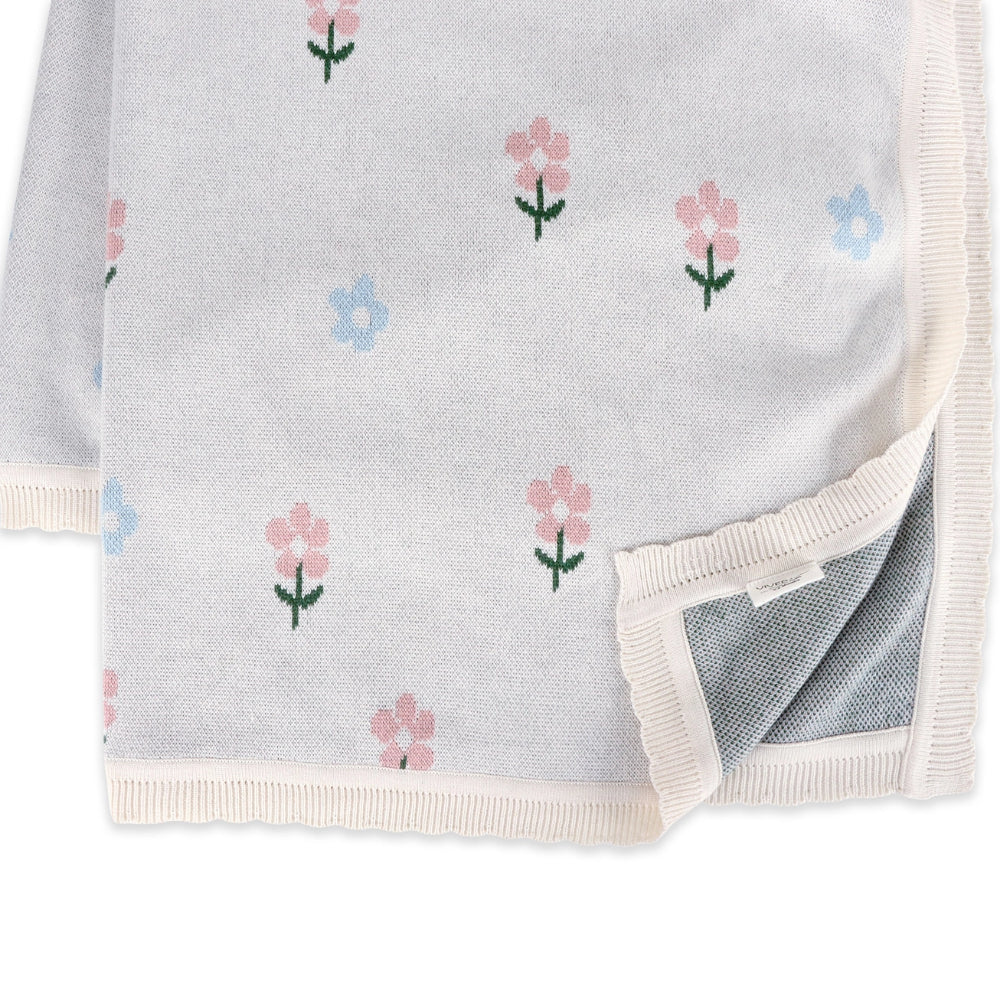 Gray blanket with floral pattern on a white background.