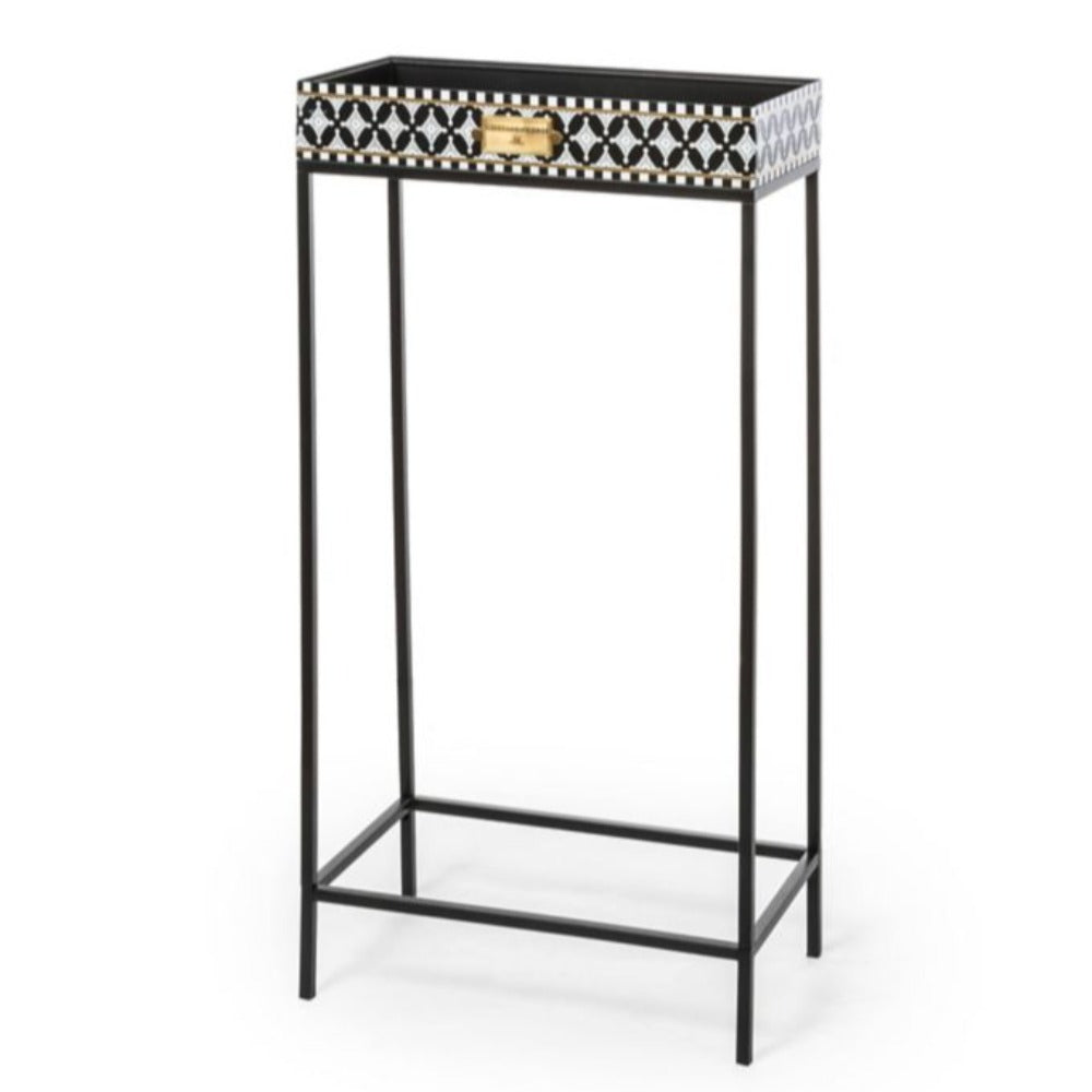 Decorative side table with a white geometric pattern on a white background
