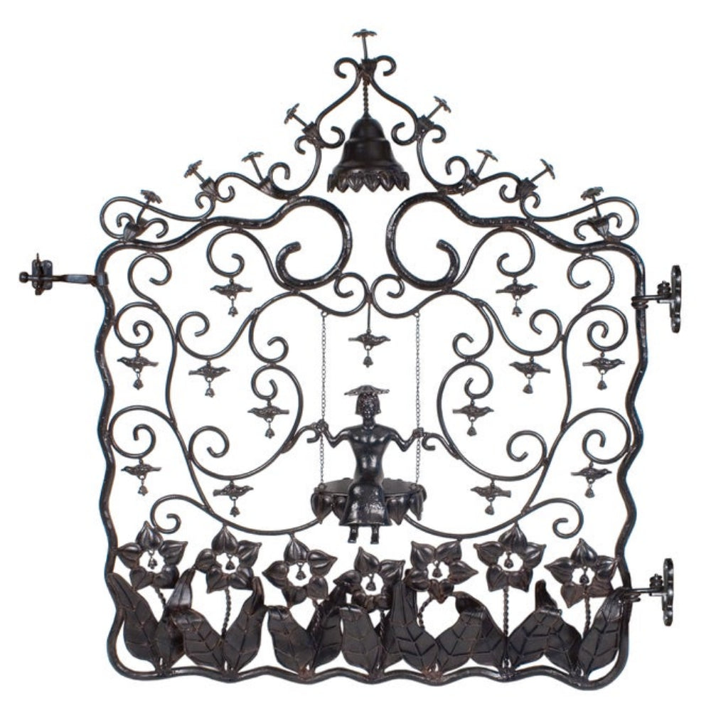 Decorative metal wall art with intricate designs and a central figure on a white background